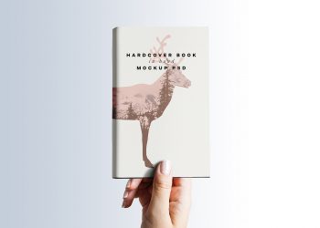 Hardcover Book in Hand Mockup PSD
