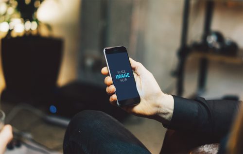 Man Looking At iPhone Mockup