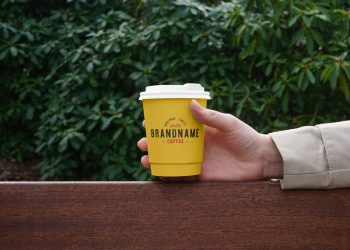 Hand Holding Coffee Cup PSD Mockup