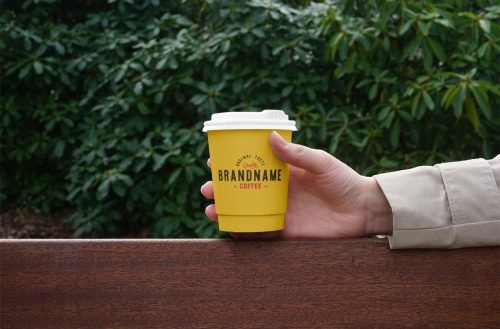 Hand Holding Coffee Cup PSD Mockup