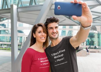 Free Round Neck T-Shirt Mockup of a Couple Taking a Selfie