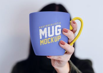 Free Mug in Female Hand Mockup PSD