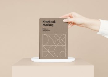 Notebook with Hand Mockup