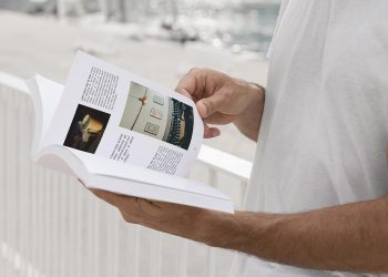 Man on Street Reading Book Free Mockup