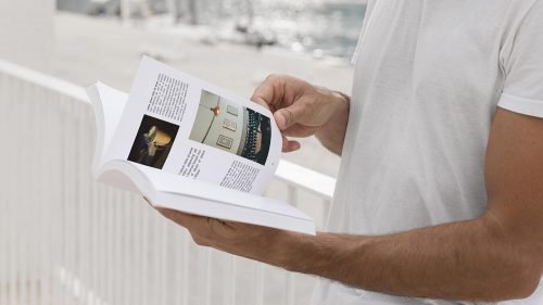 Man on Street Reading Book Free Mockup