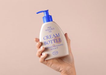 Hand Holding Cosmetic Bottle Psd Mockup