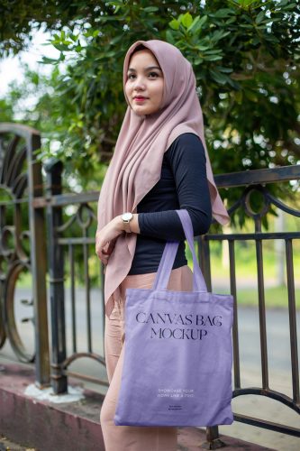 Woman in Park Holding Canvas Bag Free Mockup